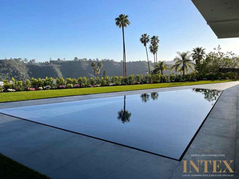 Infinity pool with scenic hillside view.