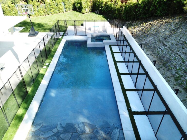 Aerial view of fenced-in swimming pool.