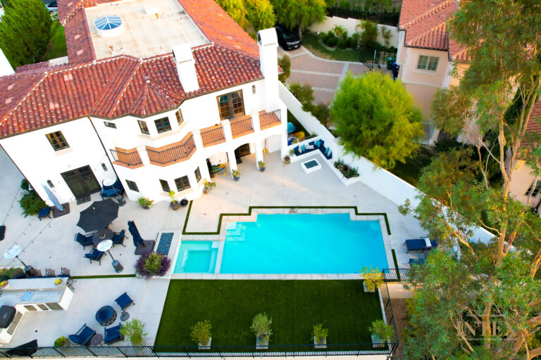 Aerial view of luxurious house with pool.