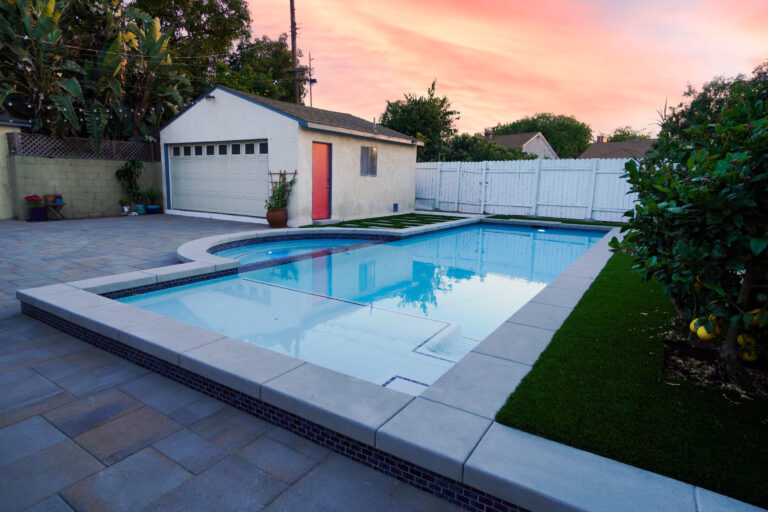 Backyard pool with a small adjacent building.