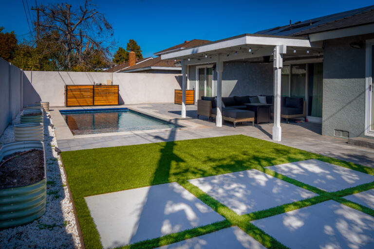 Modern backyard with pool and seating area.
