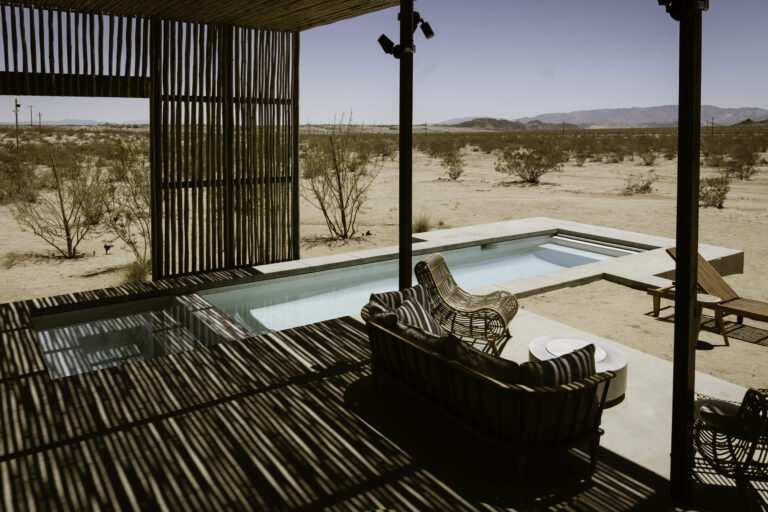 Desert patio with pool and seating area.