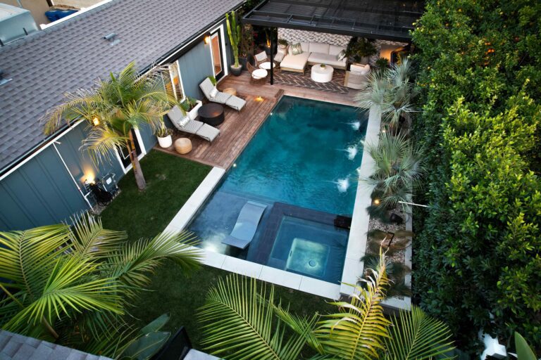 Modern backyard with pool and lounge area.